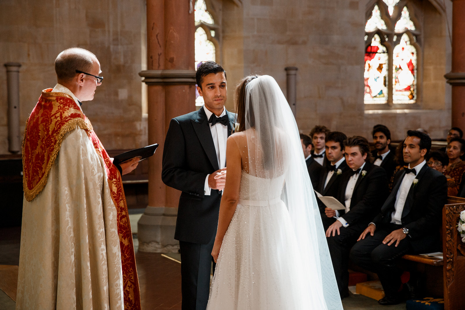 bride and groom exchanging vows at cotswolds wedding day