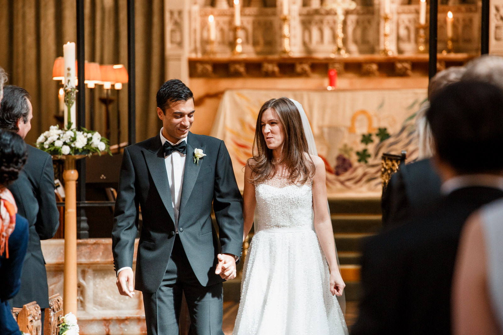 bride and groom walking down aisle after getting married