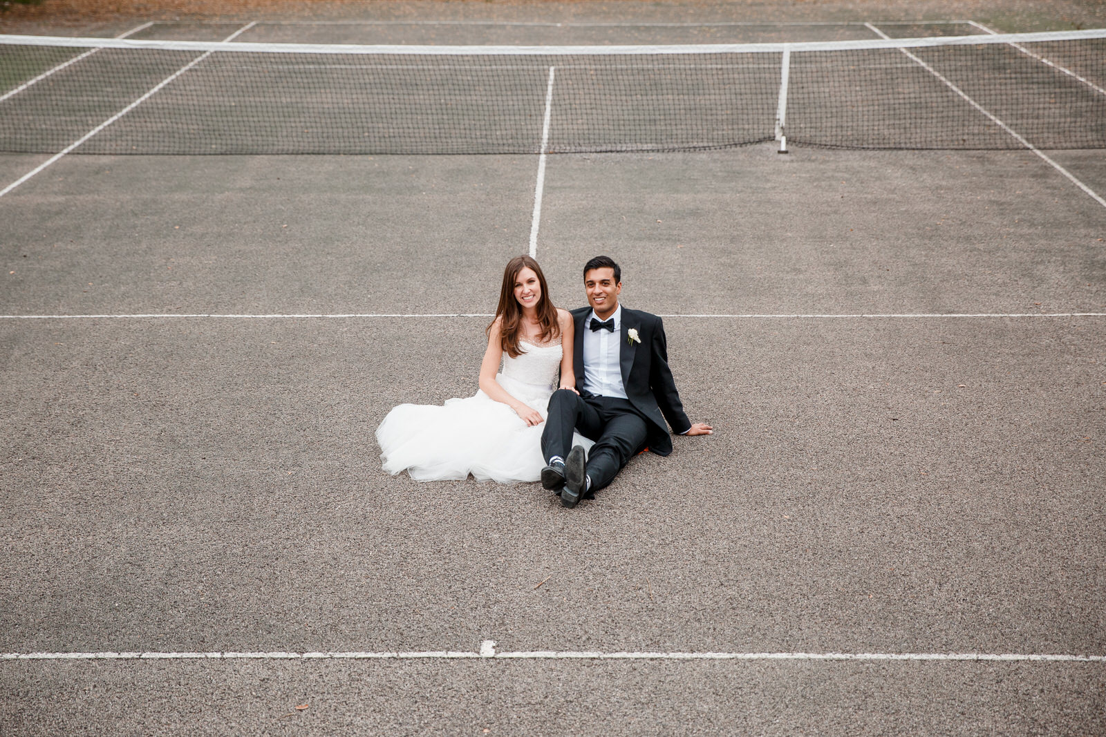 bride and groom on tennis courts at middle stanley wedding venue