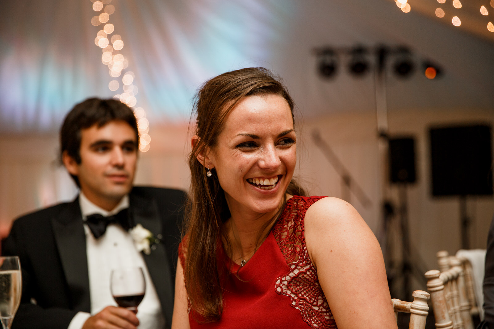 guest laughing at speeches on wedding day