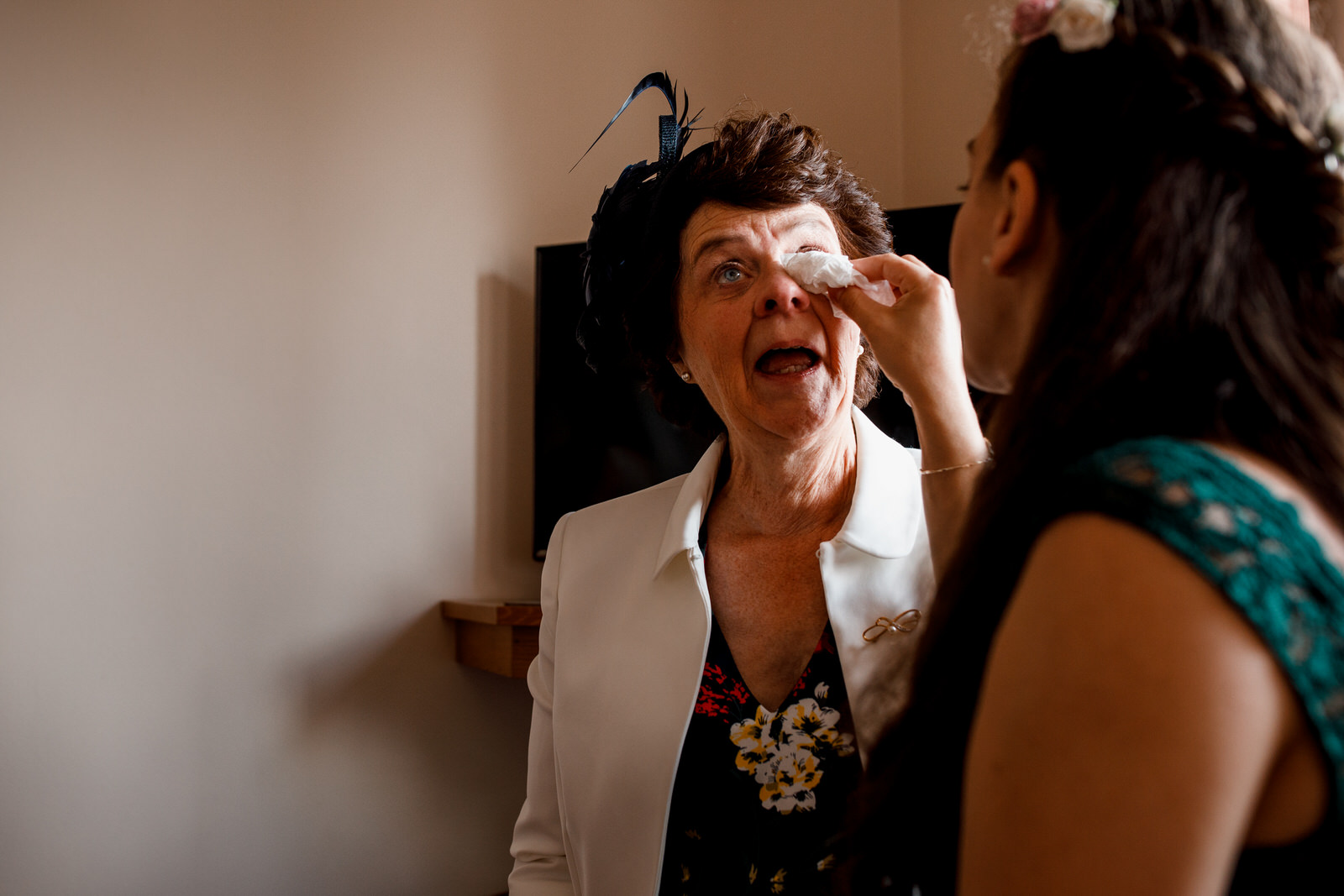 mum wiping eye at daughters wedding
