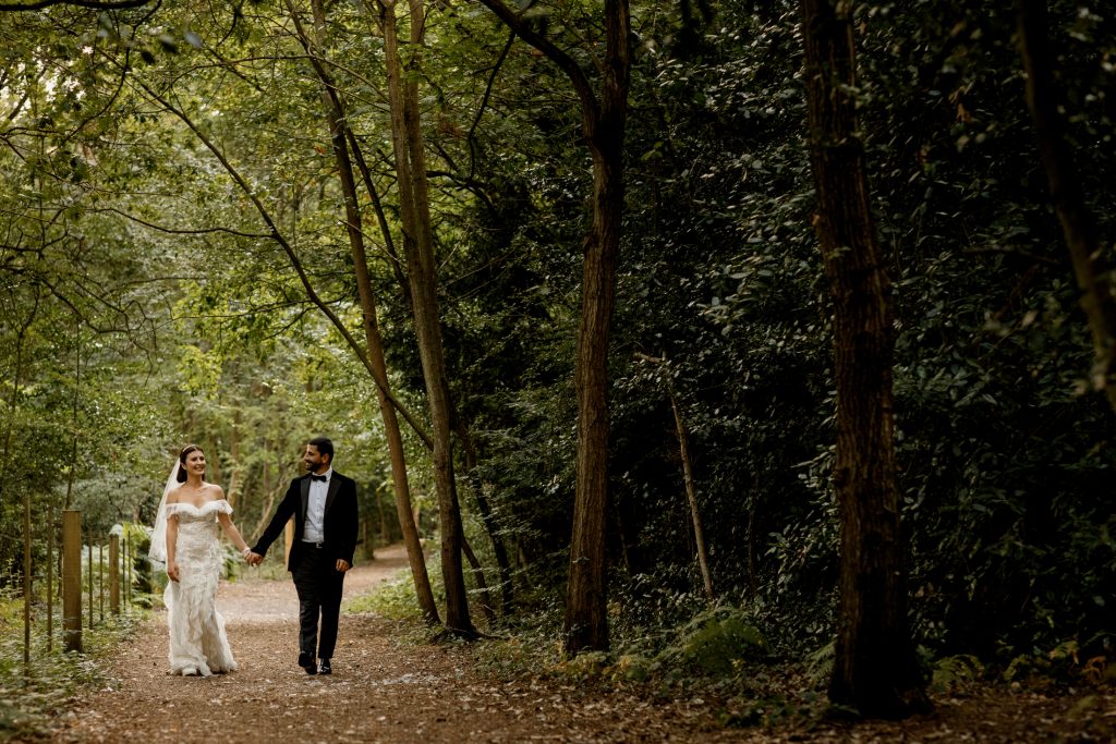 bridal couple walking in burnham beeches