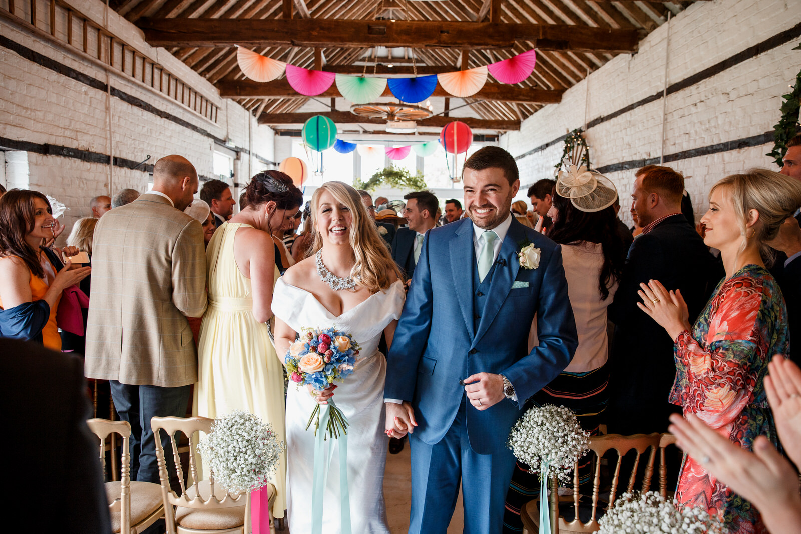 bride and groom leaving ceremony room at lillibrooke manor