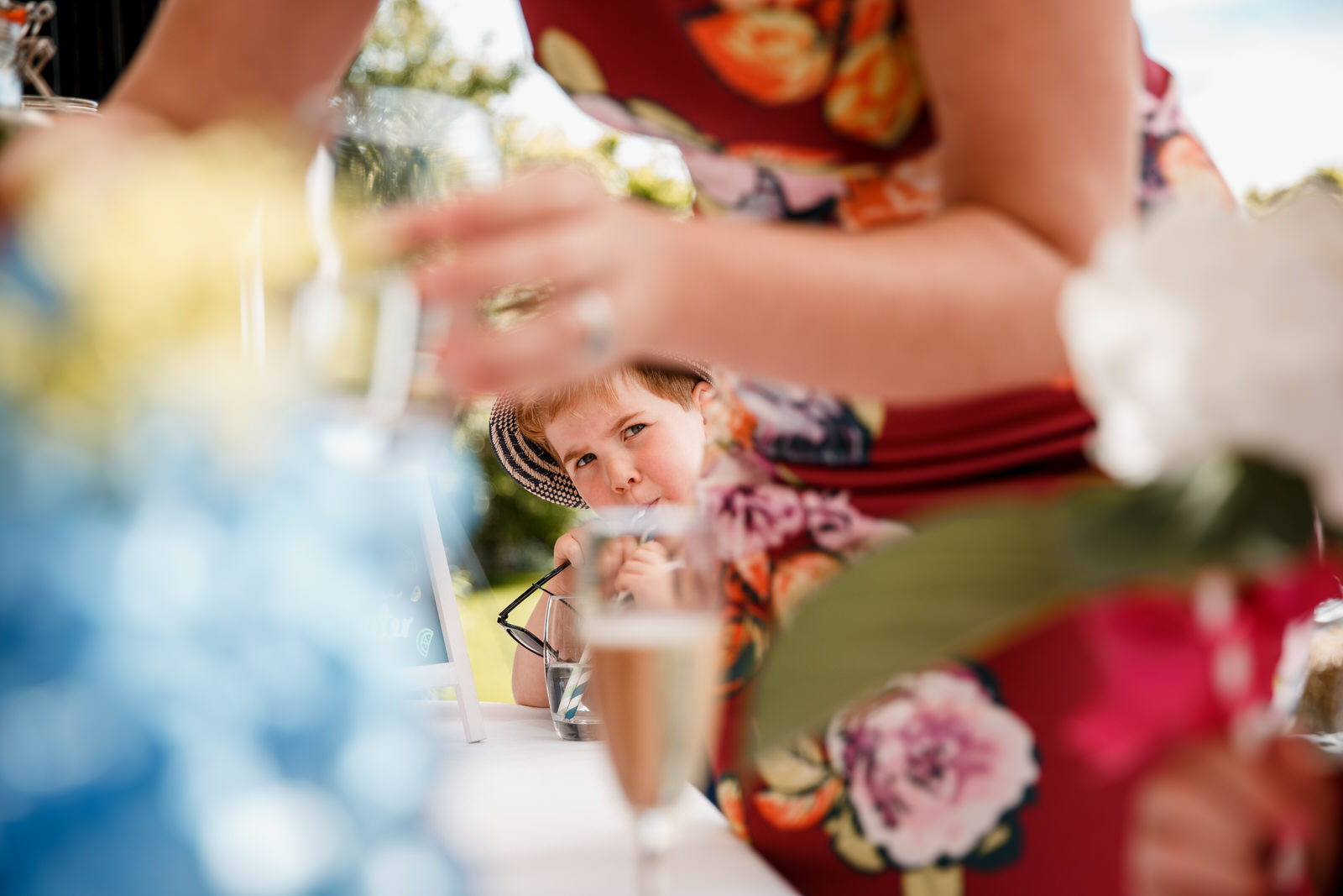 drinks reception and boy looking at mum at lillibrooke manor wedding