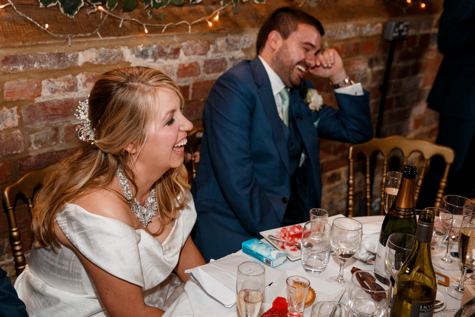 bride and groom laughing at speeches at lillibrooke manor wedding