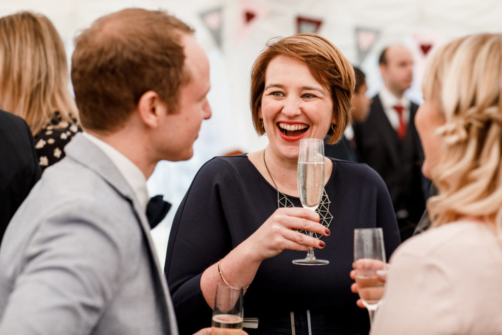 guest laughing at marquee reception