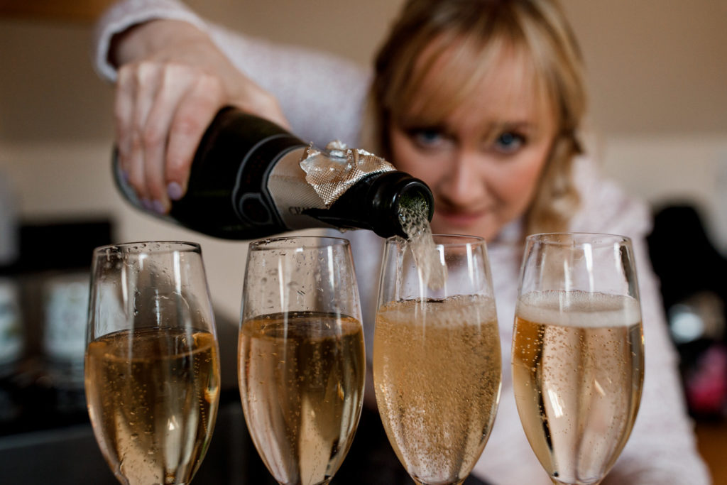 bridesmaids pouring champagne