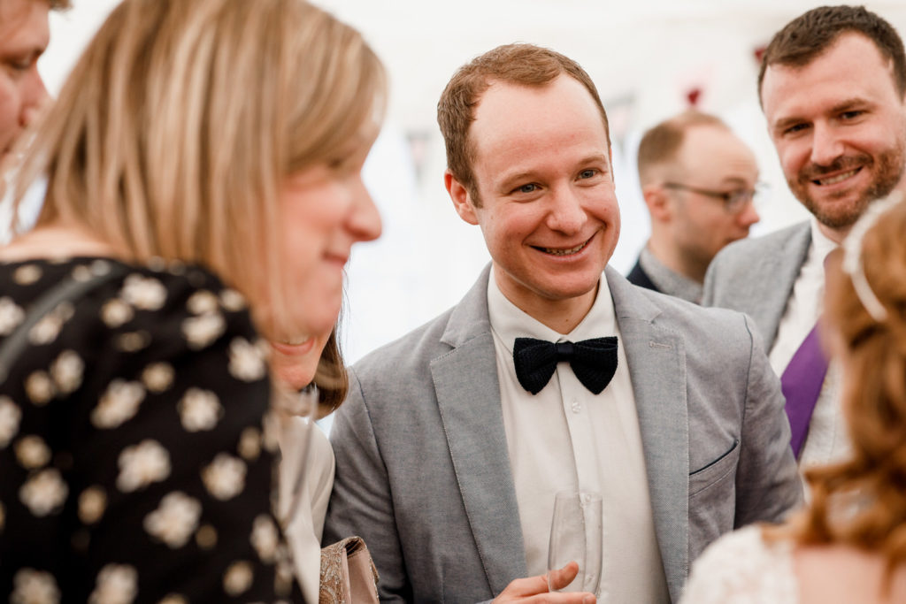 guest laughing at marquee reception
