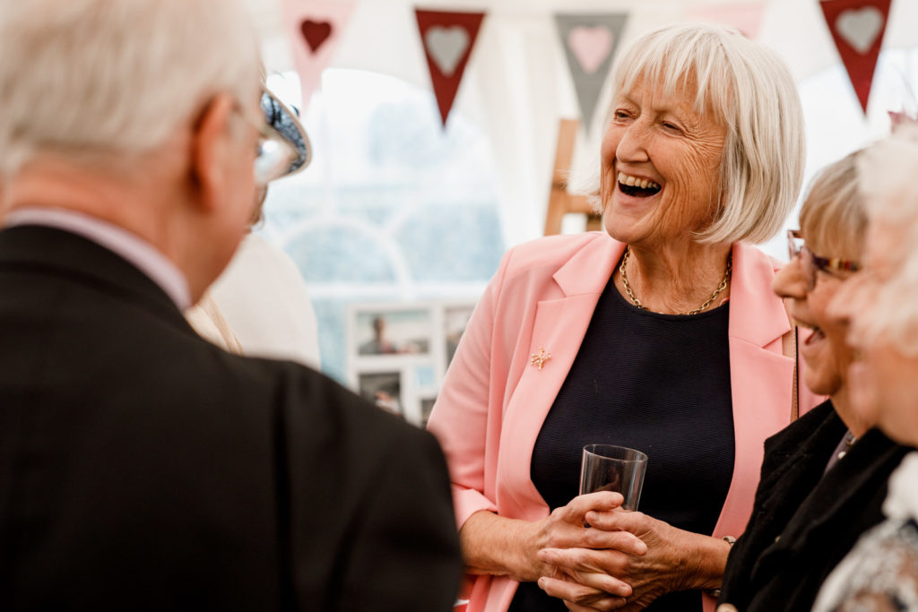 guest laughing at marquee reception