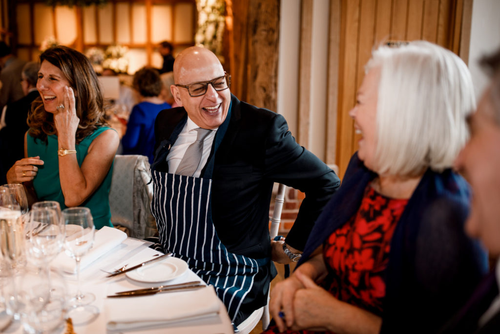 wedding guest putting on cooking apron