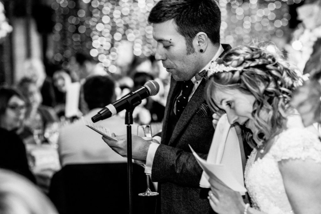 bride wiping eye at wedding