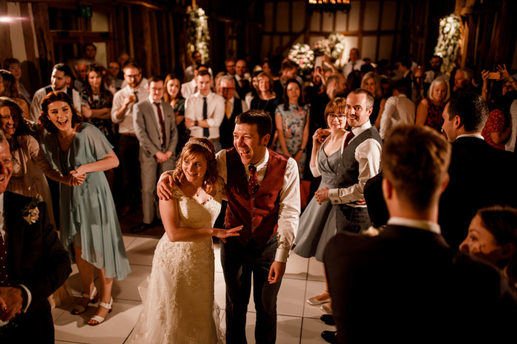 bride and groom laughing at wedding day first dance