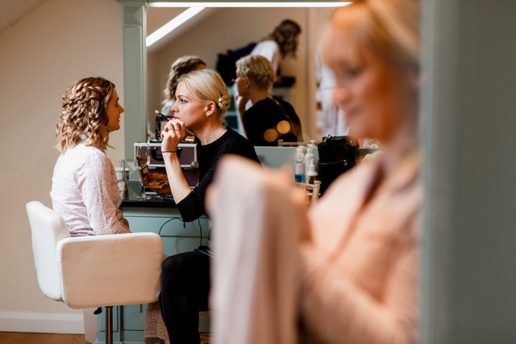 bride getting make up applied