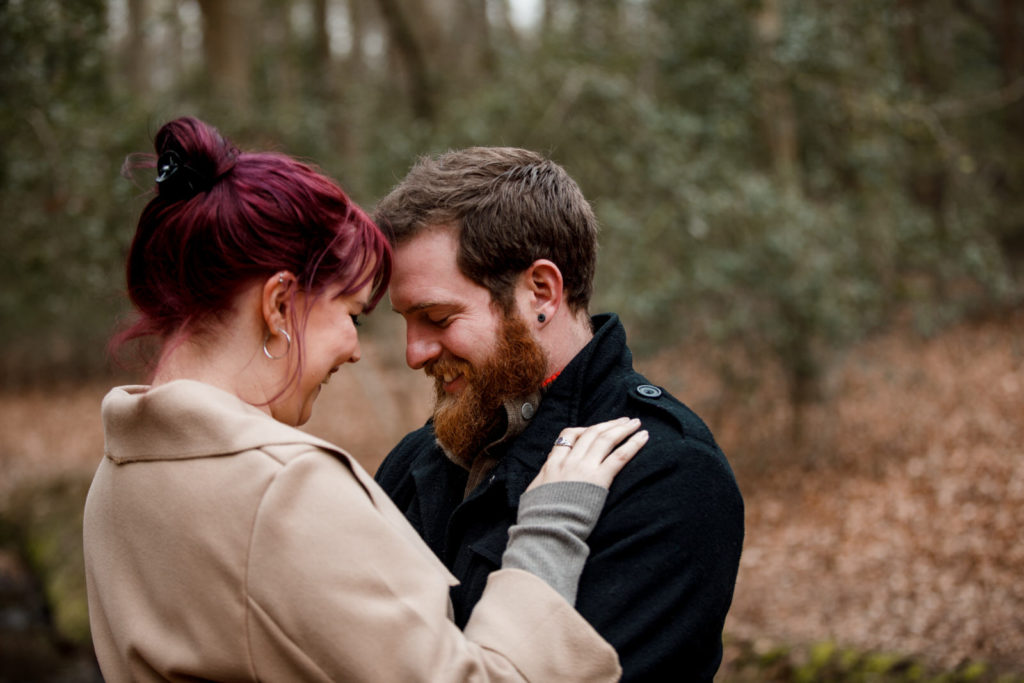 couple cuddling in burnham beeches