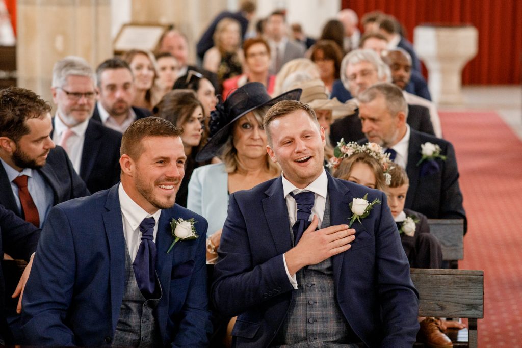 best man laughing in church at wedding