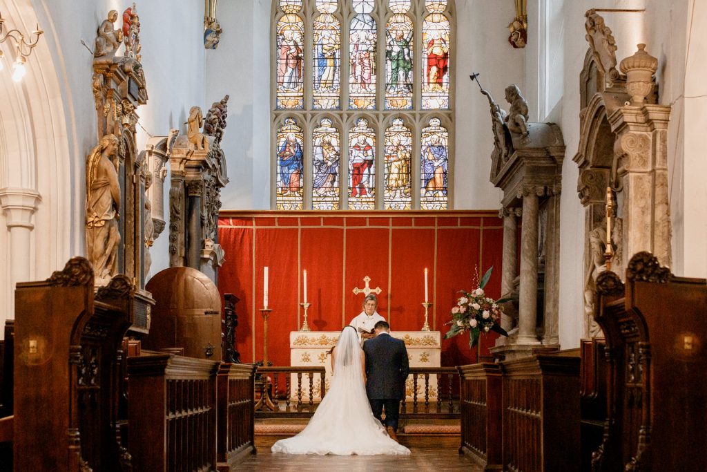 bride and groom kneeling in church