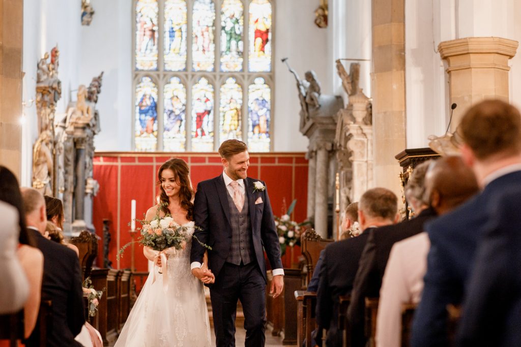 bride and groom leaving st marys church in amersham