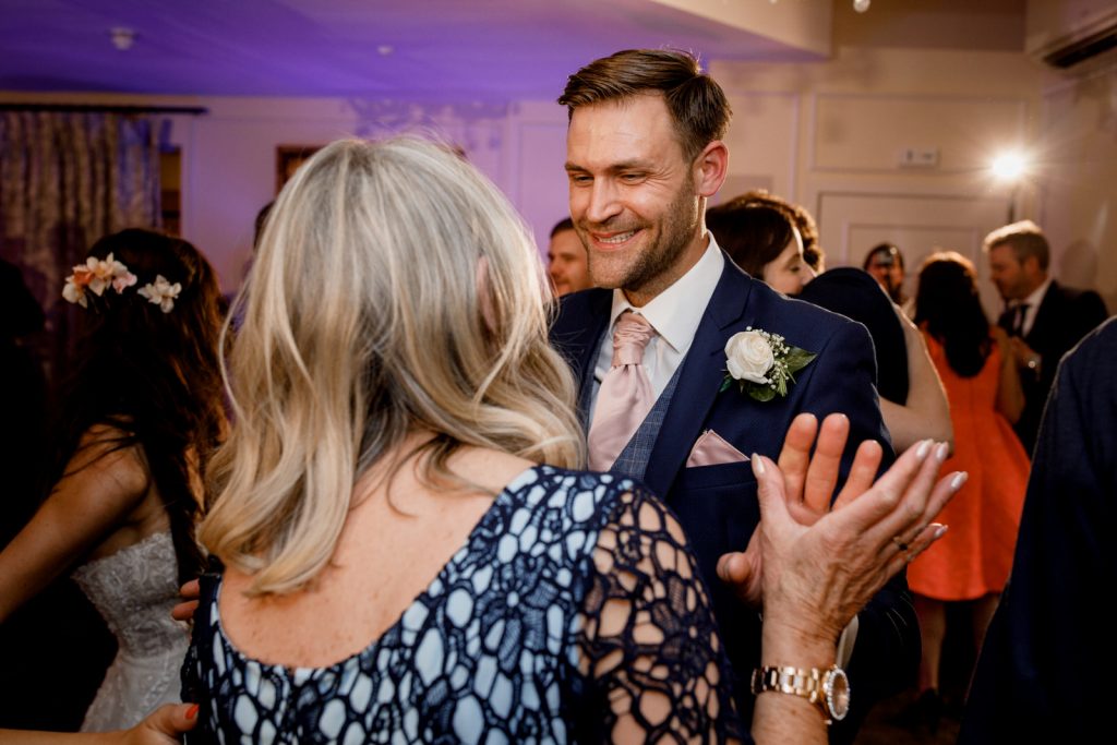 groom and mother dancing at wedding