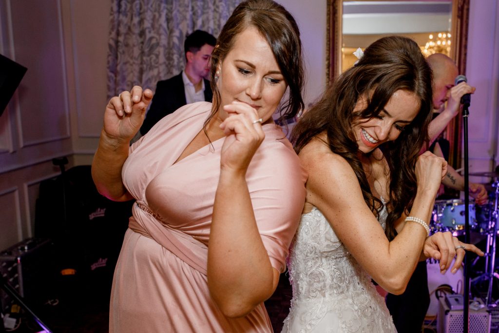 bride and bridesmaid dancing together