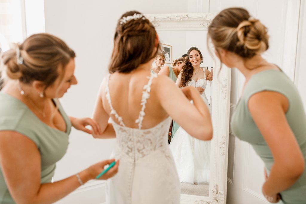 bride looking at reflection in mirror