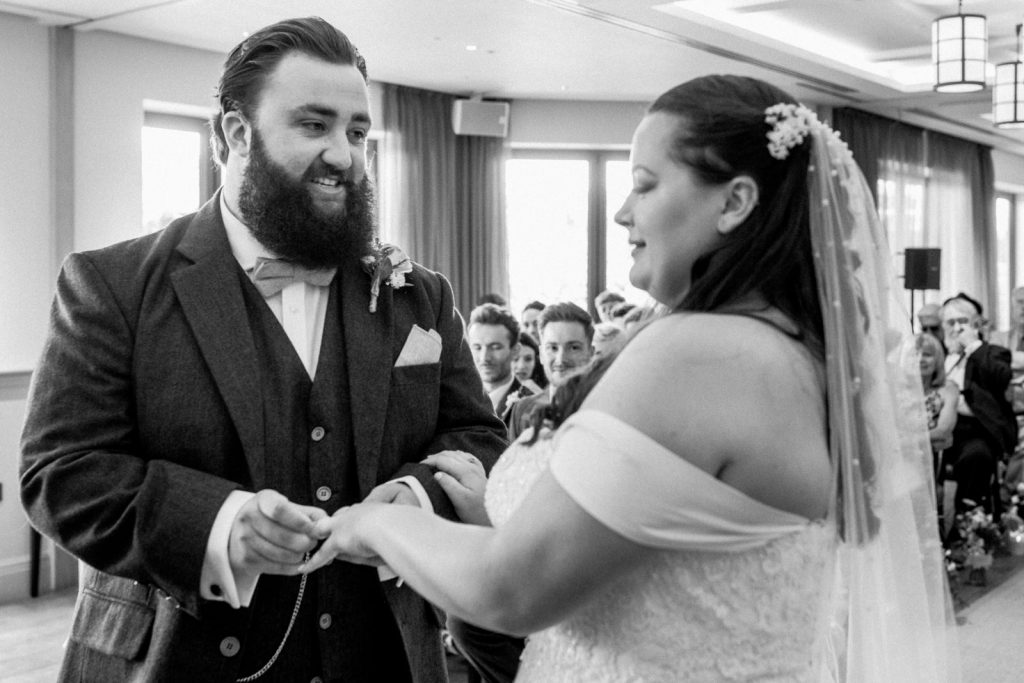 groom putting on ring