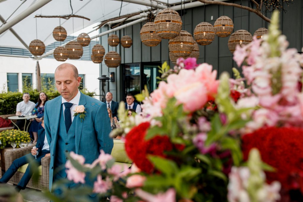 groom waiting for bride at ham yard hotel roof garden wedding