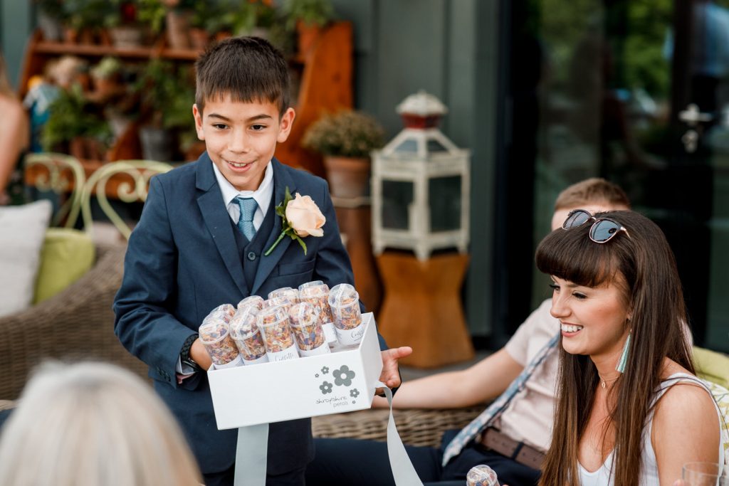 page boy giving out confetti