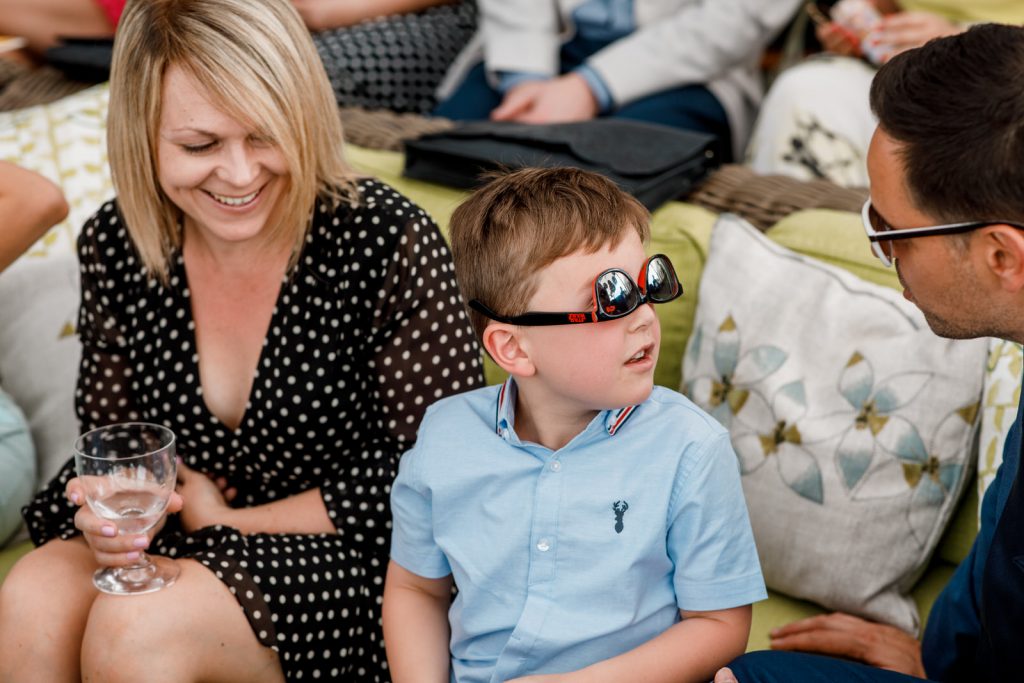 young boy with glasses on upside down