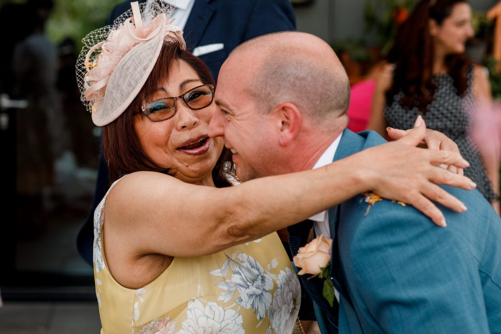 mother of the bride hugging groom