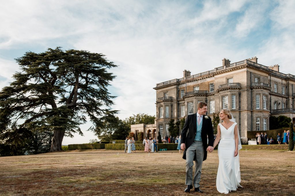 bride and groom on lawn outside hedsor house