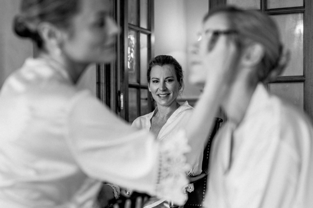 sister looking at bride getting ready in gordes wedding