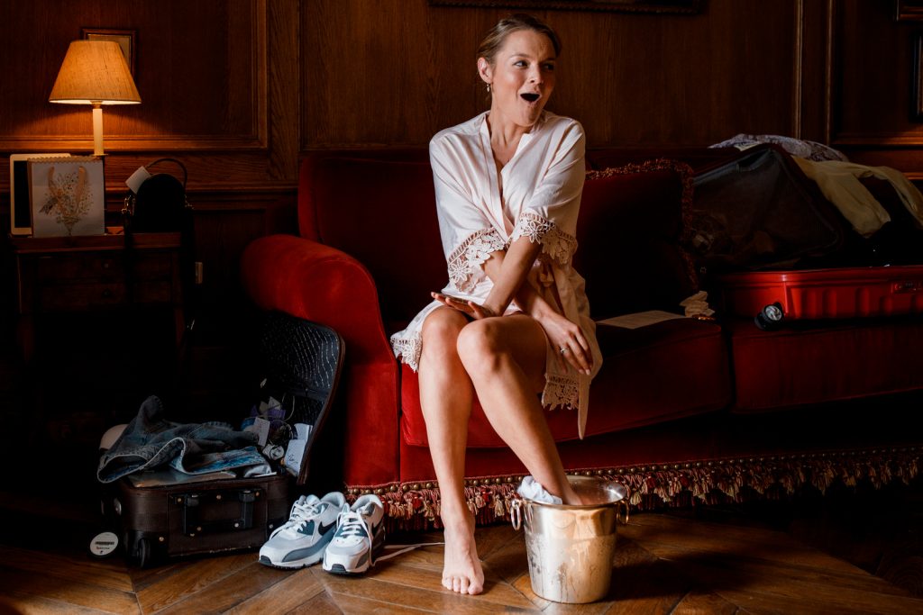 bridesmaid nursing swollen ankle in bucket of ice
