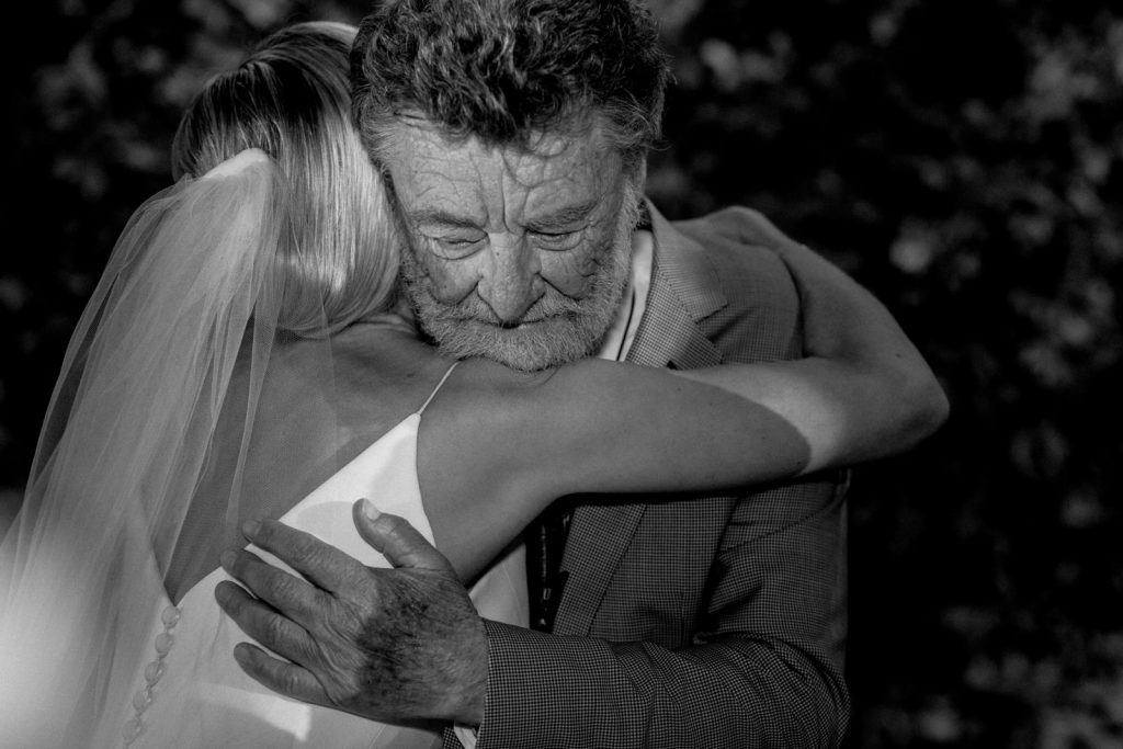 father hugging daughter on her wedding day