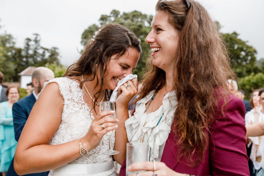groom laughing with bridesmaid