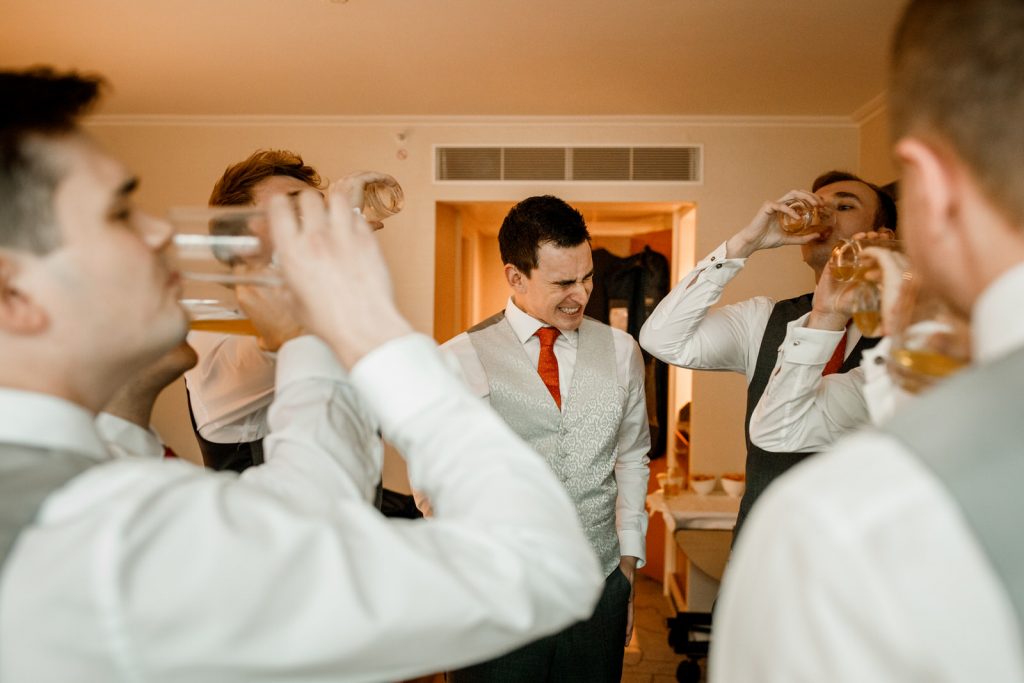 groom having shots with ushers