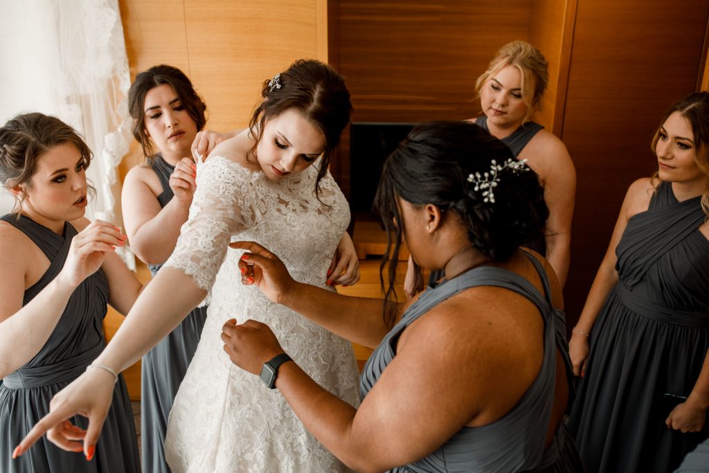 bride getting into wedding dress