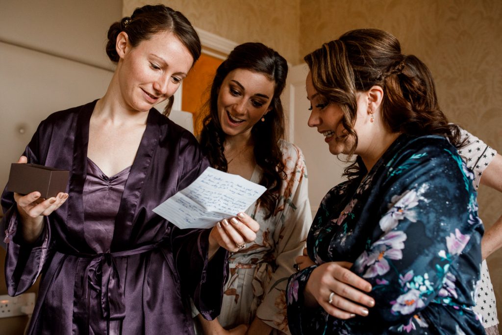 bride reading letter from groom on her wedding day