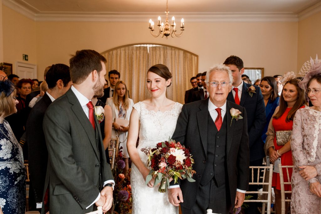 bride walking down the aisle at pembroke lodge wedding