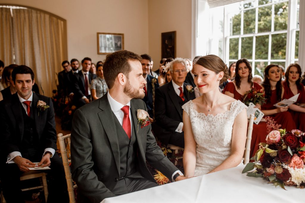 bride and groom smiling at each other during wedding at pembroke lodge