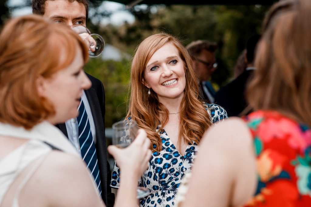 guests laughing outside at pembroke lodge wedding venue