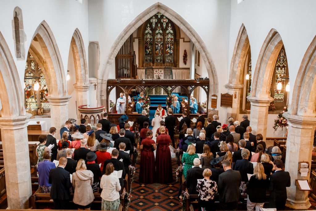 aerial shot of church in henley with bride and groom at altar
