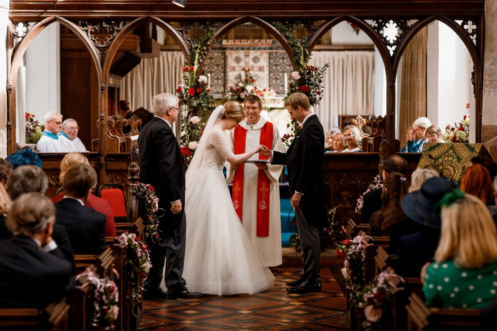 bride and groom exchanging rings