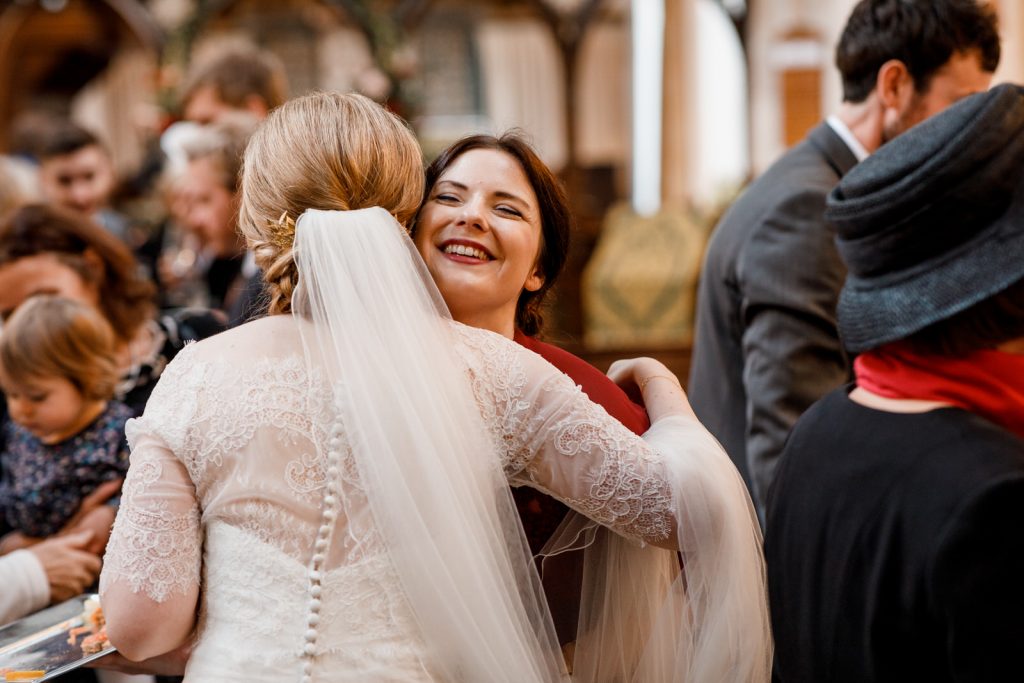bride and bridesmaid hugging