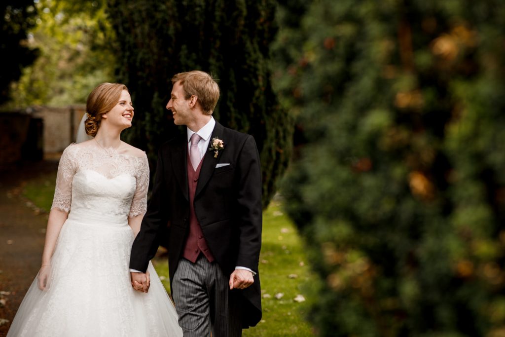 bride and groom walking away from church in henley