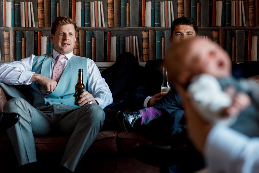 groom relaxing with beer before wedding