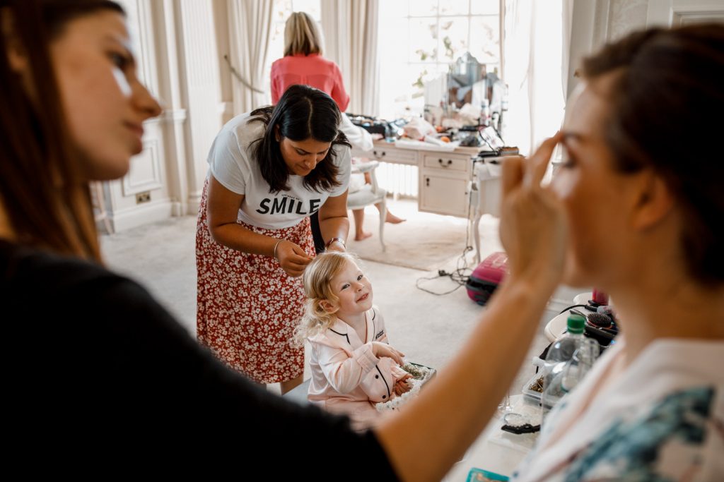 flower girl looking at bridesmaid in bridal suite at hedsor house