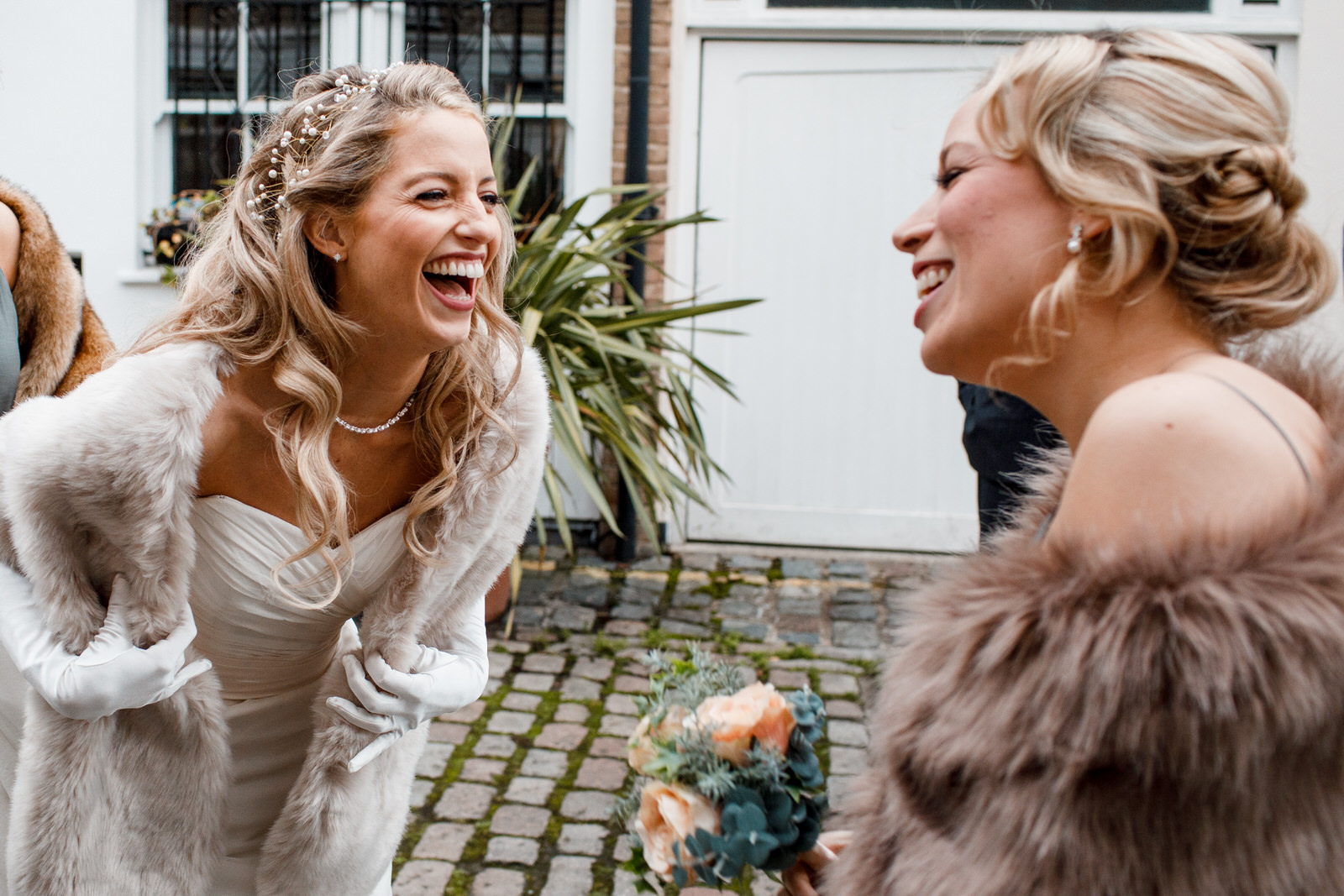 bride and bridesmaid laughing