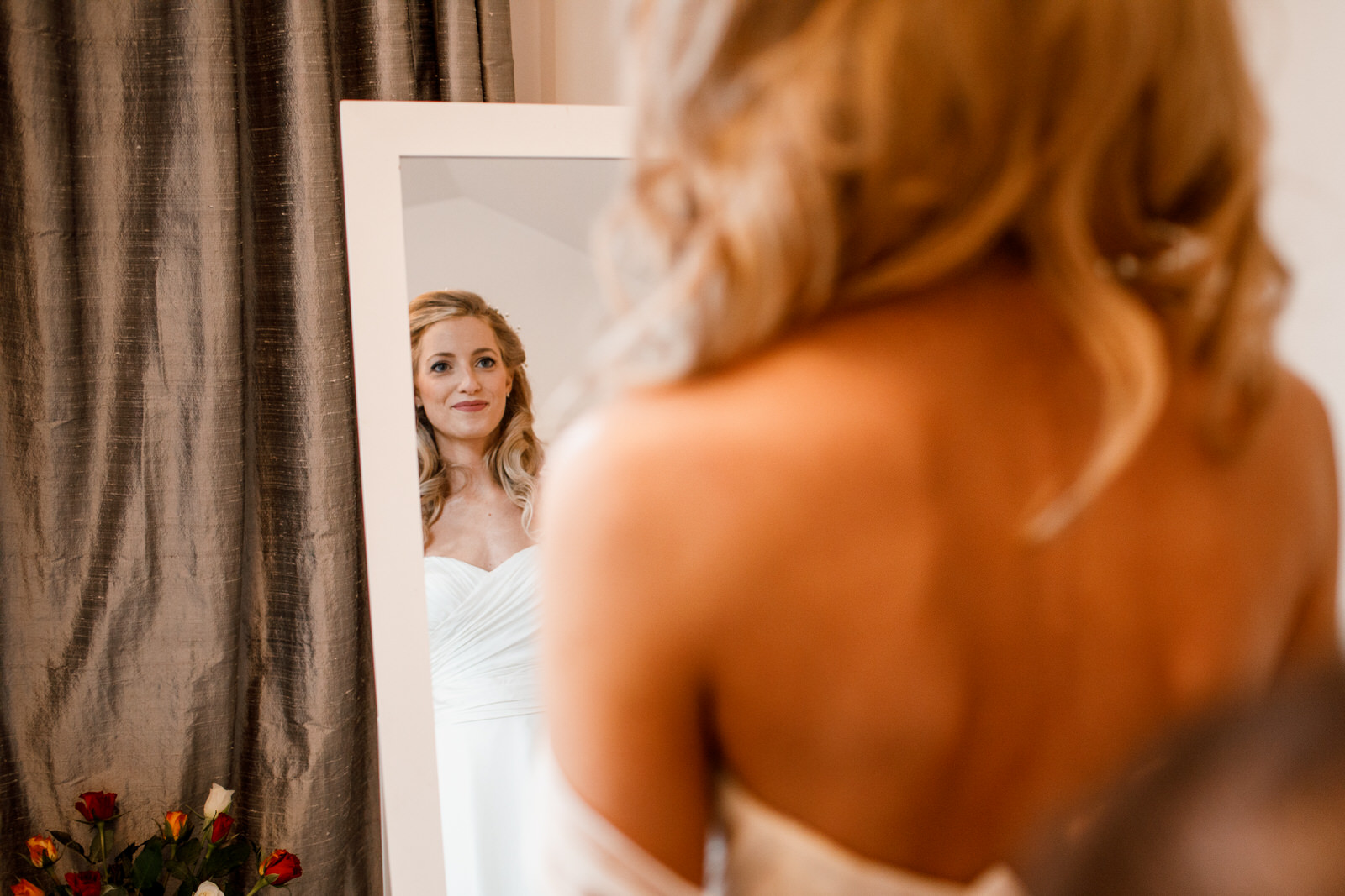 bride getting ready looking in mirror