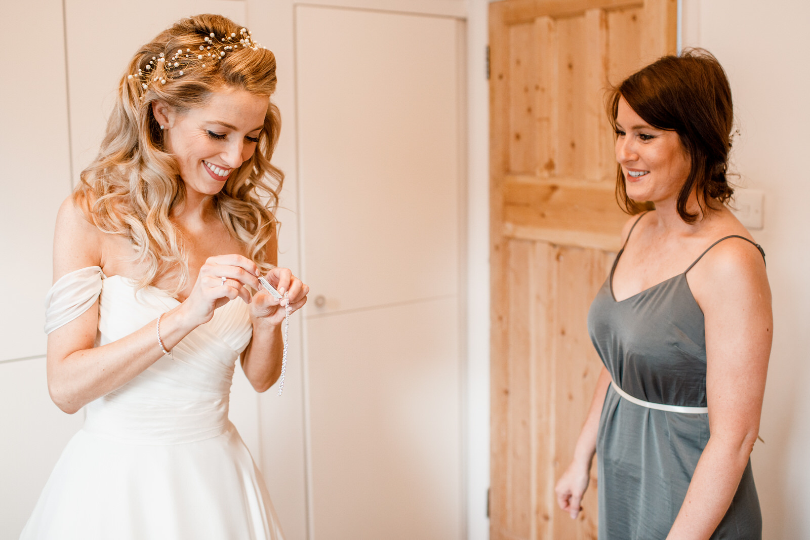 bride and bridesmaid getting ready