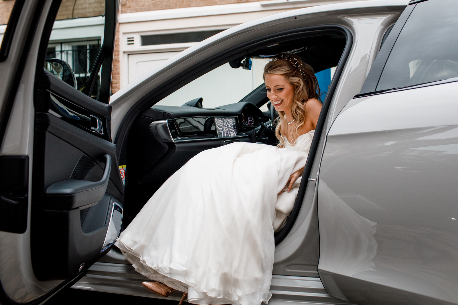 bride getting out of a porsche
